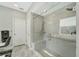 Modern bathroom features a glass enclosed shower with a built in seat and gray stone tile at 12026 Perennial Pl, Bradenton, FL 34211
