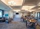 Spacious clubhouse featuring elegant chandeliers, comfortable seating, and tables for gathering at 12404 Golden Sage Dr, Sarasota, FL 34238