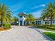Elegant clubhouse entrance with well-maintained landscaping, stately building and brick pavers at 12404 Golden Sage Dr, Sarasota, FL 34238