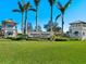 Elegant community entrance with lush landscaping and stately signage for Hammock Preserve at 12404 Golden Sage Dr, Sarasota, FL 34238