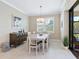 Cozy dining room featuring a white table, pendant lighting, and an open view to the outdoor area at 12404 Golden Sage Dr, Sarasota, FL 34238