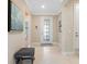 Inviting entryway featuring tile flooring, neutral walls, and a decorative front door at 12404 Golden Sage Dr, Sarasota, FL 34238