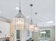 Elegant pendant lights illuminating a modern kitchen with an open layout and stylish decor at 12404 Golden Sage Dr, Sarasota, FL 34238