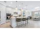 Modern, spacious kitchen with white cabinets, stainless steel appliances, a large island, and pendant lighting at 12404 Golden Sage Dr, Sarasota, FL 34238
