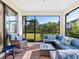 Relaxing screened lanai with cozy blue seating, ideal for enjoying the serene outdoor views at 12404 Golden Sage Dr, Sarasota, FL 34238