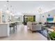 Bright and airy open-concept living room with modern decor, tile floors, and view to the outside at 12404 Golden Sage Dr, Sarasota, FL 34238