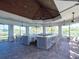 Outdoor kitchen featuring a large counter with bar stools and beautiful landscaping at 12404 Golden Sage Dr, Sarasota, FL 34238