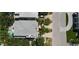 Aerial view of a beautiful coastal home with a pool, spa, and lush landscaping at 130 50Th St, Holmes Beach, FL 34217