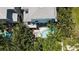 A captivating aerial view of a stunning coastal home, showcasing its pool and surrounding tropical greenery at 130 50Th St, Holmes Beach, FL 34217