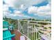 View from a balcony overlooking lush greenery and other homes in the neighborhood at 130 50Th St, Holmes Beach, FL 34217