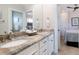 Bathroom featuring a double vanity with a granite countertop and neutral toned decor at 130 50Th St, Holmes Beach, FL 34217