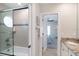 Modern bathroom with tile shower, granite vanity, and doorway to a bedroom at 130 50Th St, Holmes Beach, FL 34217