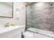 Elegant bathroom with a glass-enclosed shower and decorative gray accent tiling at 130 50Th St, Holmes Beach, FL 34217