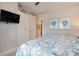 This bedroom has neutral walls, a TV, and access to an outdoor patio at 130 50Th St, Holmes Beach, FL 34217