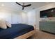 This bedroom features a ceiling fan, large closets, and a blue accent dresser at 130 50Th St, Holmes Beach, FL 34217