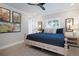 Comfortable bedroom with light wood floors, ceiling fan, and a calming blue and white color scheme at 130 50Th St, Holmes Beach, FL 34217