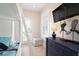 Bright bedroom featuring built-in bunk beds with a ladder, television, and nautical decor at 130 50Th St, Holmes Beach, FL 34217