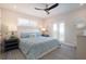 Serene bedroom with a ceiling fan, access to balcony and a bed with decorative pillows at 130 50Th St, Holmes Beach, FL 34217