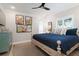 Comfortable bedroom with light wood floors, ceiling fan, and a calming blue and white color scheme at 130 50Th St, Holmes Beach, FL 34217