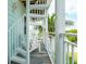 View of a white metal spiral staircase with seating area on a porch at 130 50Th St, Holmes Beach, FL 34217