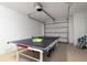 Spacious garage with ping pong table and garage door at 130 50Th St, Holmes Beach, FL 34217