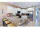 Spacious kitchen with granite countertops, stainless appliances and a breakfast bar with comfortable seating at 130 50Th St, Holmes Beach, FL 34217