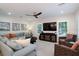 Comfortable living room with a plush sofa, woven accent chairs, and large windows for natural light at 130 50Th St, Holmes Beach, FL 34217
