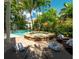 Outdoor pool and hot tub surrounded by lush greenery and lounge chairs at 130 50Th St, Holmes Beach, FL 34217