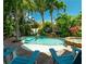 Beautiful outdoor pool and hot tub surrounded by lush greenery at 130 50Th St, Holmes Beach, FL 34217