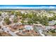 Aerial view of neighborhood with lush greenery, blue house, and neatly kept yards at 13365 Drayton Dr, Spring Hill, FL 34609