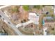 Aerial shot of a home featuring a long driveway and nearby properties with pools at 13365 Drayton Dr, Spring Hill, FL 34609