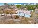 Aerial view of a well-kept home featuring a long driveway, mature trees, and a private backyard at 13365 Drayton Dr, Spring Hill, FL 34609