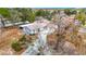 Aerial view of a home with a well-maintained yard, mature trees, and extended driveway at 13365 Drayton Dr, Spring Hill, FL 34609