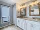 A bathroom featuring a double vanity, marble countertop, and modern fixtures at 13365 Drayton Dr, Spring Hill, FL 34609
