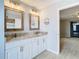 A bathroom featuring a double vanity, marble countertop, and modern fixtures at 13365 Drayton Dr, Spring Hill, FL 34609