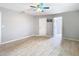 A spacious room with tiled floor, ceiling fan, and a door to an adjoining room at 13365 Drayton Dr, Spring Hill, FL 34609