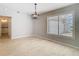 Dining area with wood-look tile floors, a large window, and modern pendant lighting at 13365 Drayton Dr, Spring Hill, FL 34609
