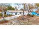 Charming single-story home with mature trees, a large driveway, and a well-manicured lawn at 13365 Drayton Dr, Spring Hill, FL 34609