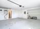 Spacious garage interior with utility sink and overhead lighting at 13365 Drayton Dr, Spring Hill, FL 34609