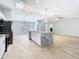 Open floor plan features kitchen island with seating and stainless appliances at 13365 Drayton Dr, Spring Hill, FL 34609