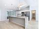 Open kitchen featuring stone countertops, stainless appliances, tile floors, and abundant lighting at 13365 Drayton Dr, Spring Hill, FL 34609
