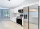 Modern kitchen with stainless steel appliances, white cabinets, and plenty of counter space at 13365 Drayton Dr, Spring Hill, FL 34609
