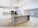 Bright kitchen featuring a central island, granite countertops, and pendant lighting at 13365 Drayton Dr, Spring Hill, FL 34609