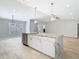Bright kitchen with island features stone countertops, stainless steel appliances and tile floors at 13365 Drayton Dr, Spring Hill, FL 34609