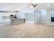 Open floor plan with spacious kitchen, island, and living room featuring tile floors at 13365 Drayton Dr, Spring Hill, FL 34609
