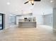 Spacious open floorplan with vaulted ceilings, a kitchen island, and tile flooring at 13365 Drayton Dr, Spring Hill, FL 34609