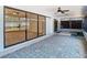 Enclosed sunroom with ceiling fan, rug, and sliding glass doors to the backyard at 13365 Drayton Dr, Spring Hill, FL 34609