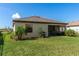A well maintained backyard features a covered patio, lush lawn and small garden at 15246 Serene Shores Loop, Bradenton, FL 34211