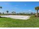 Outdoor volleyball court with lush landscaping, providing a fun recreational amenity for residents at 15246 Serene Shores Loop, Bradenton, FL 34211