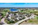 Spectacular aerial view of the Lodge's Golf and Country Club, showcasing the lush greenery and serene lake at 15606 Leven Links Pl, Lakewood Ranch, FL 34202